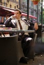 A young businessman came to lunch in a cafe, he sits at a table and waits someone