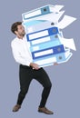 Young businessman carrying a stack of binders Royalty Free Stock Photo