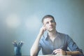 Young businessman caucasians sitting at desk office table and taking notes in notebook. Writing and looking to right hand side