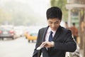 Young Businessman checking the time, waiting for the bus Royalty Free Stock Photo