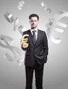 Young businessman chooses a Gold Euro Sign Royalty Free Stock Photo