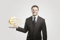 Young businessman chooses a Gold Euro Signs. Royalty Free Stock Photo