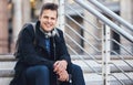 Young businessman, city and portrait on stairs for travel from work with smile, happiness and sitting. Executive man Royalty Free Stock Photo