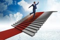 The young businessman climbing stairs and red carpet into sky Royalty Free Stock Photo