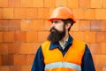 Young businessman construction site engineer, close up. Caucasian young builder standing. Worker portrait. Bearded
