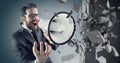 Young businessman crushing concrete wall with a megaphone