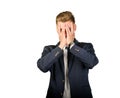 Young businessman in despair covers his face. Royalty Free Stock Photo