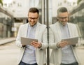 Young businessman with digital tablet by the office building Royalty Free Stock Photo