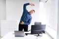 Young Businessman Doing Stretching Exercise Royalty Free Stock Photo