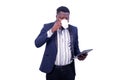 Young businessman drinking a cup of coffee and holding a digital tablet Royalty Free Stock Photo