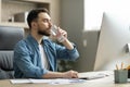 Young Businessman Drinking Water From Glass While Working At Desk In Office Royalty Free Stock Photo