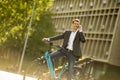 Young businessman on the ebike using mobile phone Royalty Free Stock Photo