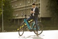 Young businessman on the ebike using mobile phone Royalty Free Stock Photo