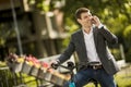 Young businessman on the ebike using mobile phone Royalty Free Stock Photo