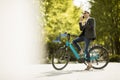 Young businessman on the ebike using mobile phone Royalty Free Stock Photo