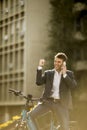 Young businessman on the ebike using mobile phone Royalty Free Stock Photo