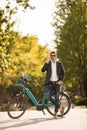 Young businessman on the ebike using mobile phone Royalty Free Stock Photo