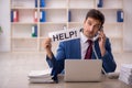 Young male employee asking for help in the office Royalty Free Stock Photo