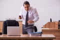 Young male employee stapling paper in the office Royalty Free Stock Photo