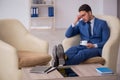 Young male employee waiting for business meeting Royalty Free Stock Photo