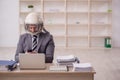 Young male employee wearing spacesuit in the office