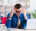 Young businessman employee working in office at desk Royalty Free Stock Photo