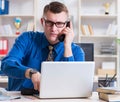 Young businessman employee working in office at desk Royalty Free Stock Photo