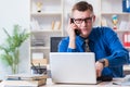 Young businessman employee working in office at desk Royalty Free Stock Photo