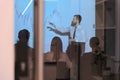 Young Businessman Explaining Graphs To His Colleagues On Projector Royalty Free Stock Photo