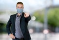 Young businessman with face mask outdoor in city