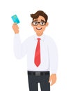 Young businessman in formal wear with red colour tie holding or showing a credit Debit, ATM card. Male character design. Royalty Free Stock Photo