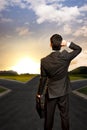 Young businessman in front of a crossroad