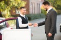 Young Businessman Getting Car Key From Valet
