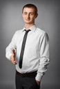 Young businessman giving hand and smiling. Royalty Free Stock Photo