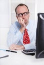 Young businessman with glasses and bald sitting in his office in Royalty Free Stock Photo