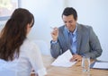 This is excellent. A young businessman going over a candidates impressive resume at a job interview. Royalty Free Stock Photo