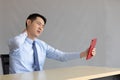 Asian young businessman have a stiff neck and holing tablet