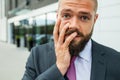 Young businessman having headache because of problems at work. Royalty Free Stock Photo