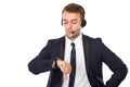 Young businessman with a headphone watching his watches