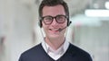 Young Businessman with Headset Smiling at the Camera Royalty Free Stock Photo