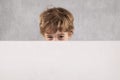 Young businessman hides behind a place for advertising, copy spa Royalty Free Stock Photo