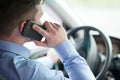 Young businessman in his car at the wheel talking on a mobile ph Royalty Free Stock Photo
