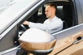 Young businessman in his car at the wheel talking on a mobile phone Royalty Free Stock Photo