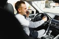 Young businessman in his car at the wheel talking on a mobile phone Royalty Free Stock Photo