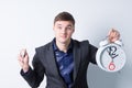 Young Businessman Holding Alarm Clock and Watch