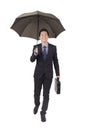 Young businessman holding black umbrella and portfolio Royalty Free Stock Photo