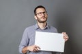 Young businessman holding a blank banner with imagination