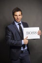 Young businessman holding a boss sign