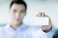 Young businessman holding business card to the camera Royalty Free Stock Photo