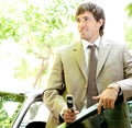 Businessman with car and phone. Royalty Free Stock Photo